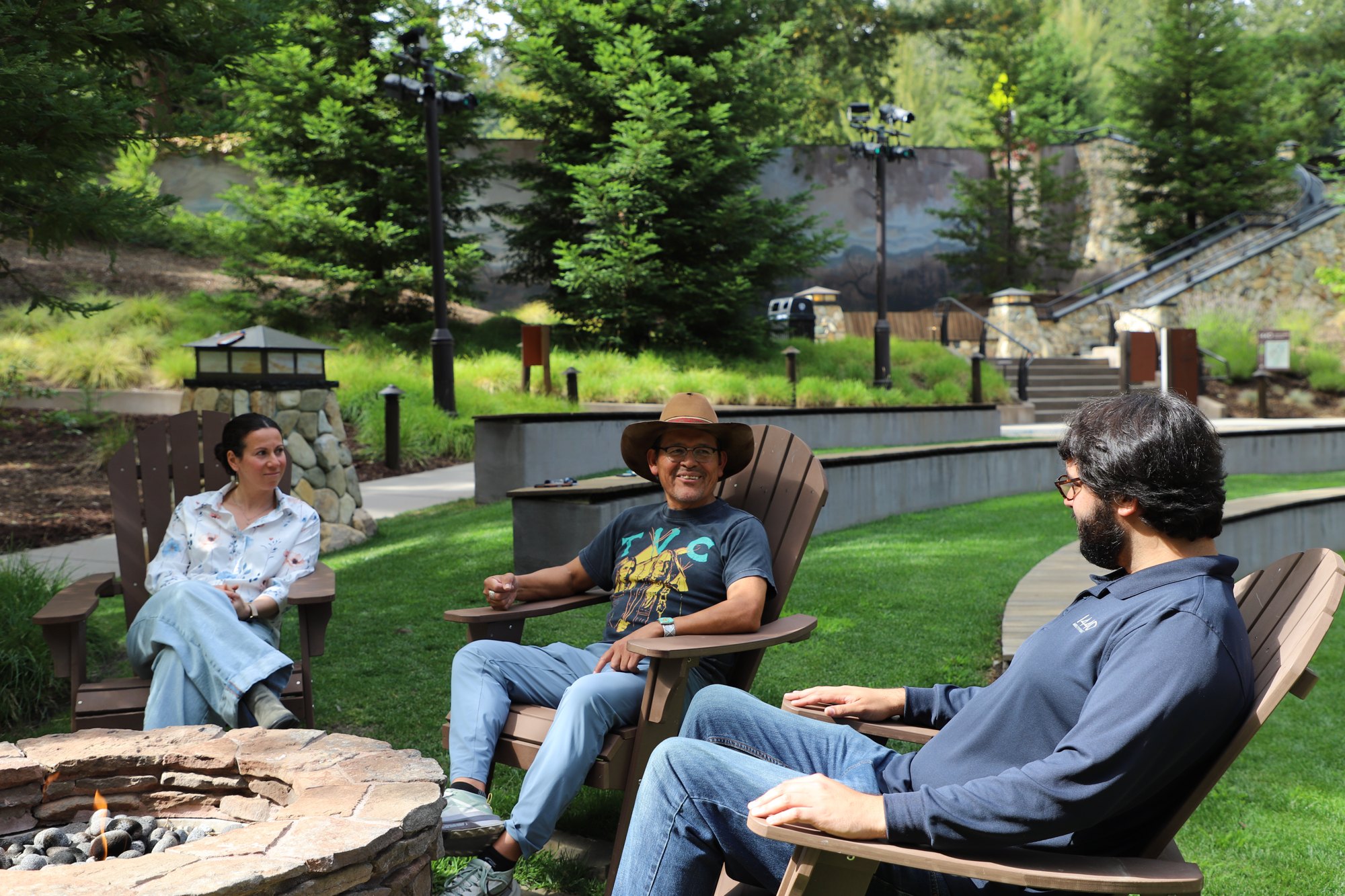 Tony in council with participants beneath the redwoods