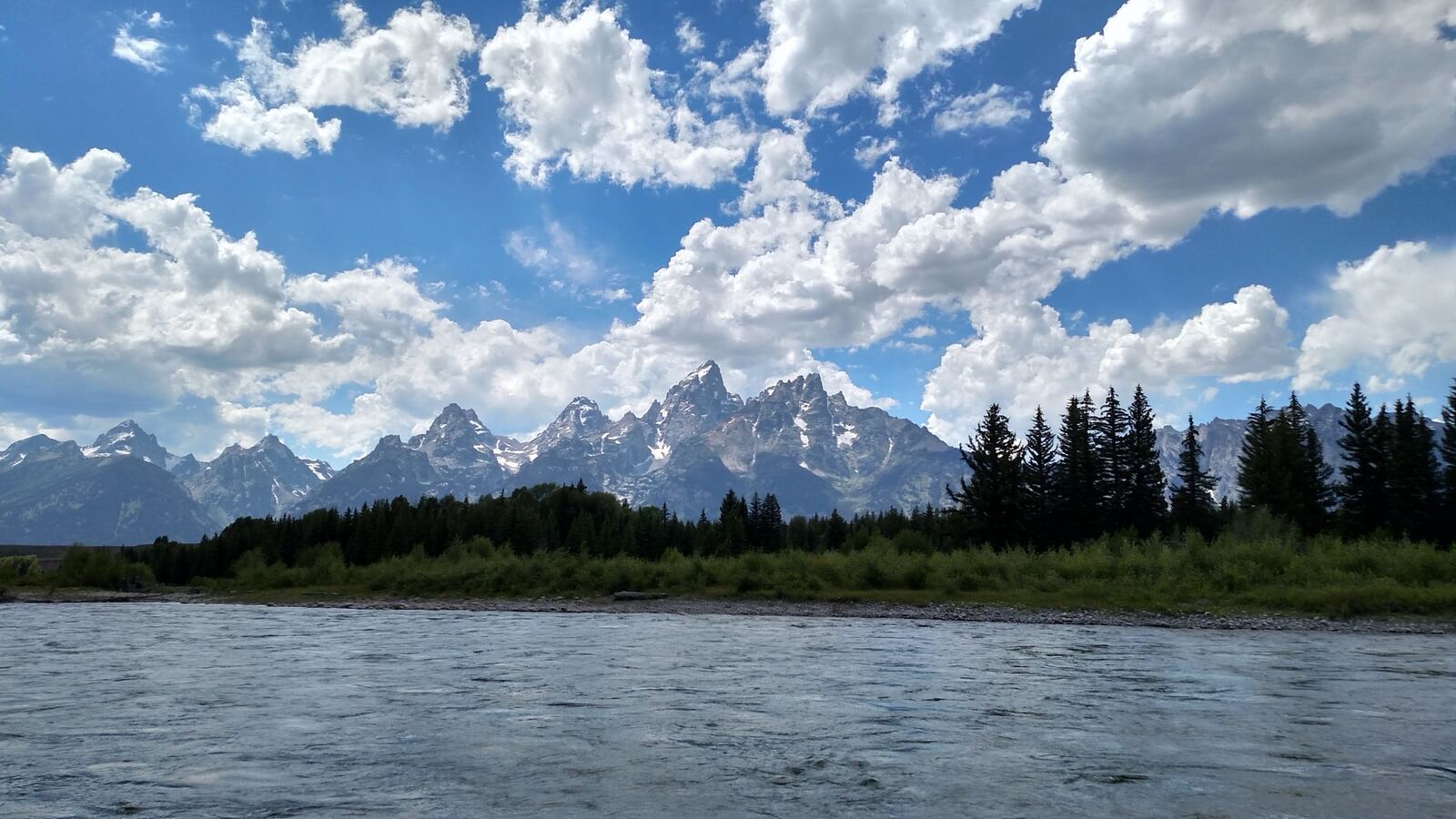 A mountain lake below snow peaks