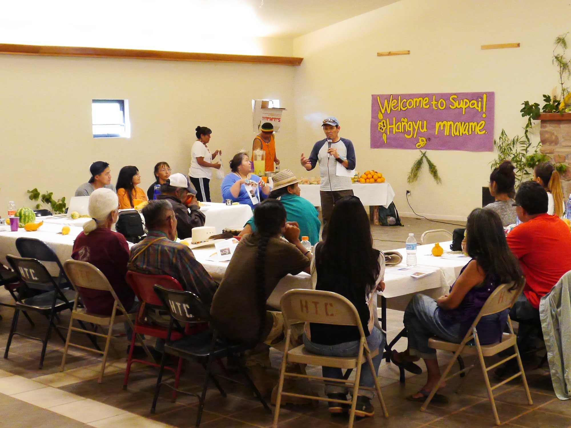 Tony in council with participants beneath the redwoods