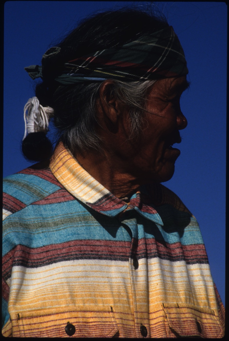 Elder in profile under open sky